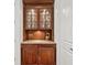 Butler's pantry with wood cabinets, glass shelves, and a stone countertop at 1031 Eulalia Ne Rd, Atlanta, GA 30319
