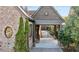 Covered driveway leads to garage with brick and wood accents, adding classic charm at 1031 Eulalia Ne Rd, Atlanta, GA 30319