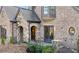 Brick and stone home showing arched entry, leaded glass window and elegant details at 1031 Eulalia Ne Rd, Atlanta, GA 30319