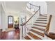 Grand foyer featuring hardwood floors and elegant staircase with wood railings at 1031 Eulalia Ne Rd, Atlanta, GA 30319