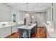 Open kitchen with stainless steel appliances, hardwood floors, and a large island with seating at 1031 Eulalia Ne Rd, Atlanta, GA 30319