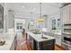 Bright kitchen with stainless steel appliances, hardwood floors, and a large island with cooktop at 1031 Eulalia Ne Rd, Atlanta, GA 30319