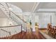 Open staircase with wood floors and white banisters overlooks dining and living spaces at 1031 Eulalia Ne Rd, Atlanta, GA 30319