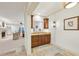 Charming wet bar with wood cabinetry, granite countertop, and adjacent living spaces at 1031 Eulalia Ne Rd, Atlanta, GA 30319