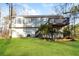 This house features a backyard with a wooden deck and large lawn at 2235 Azalea Dr, Loganville, GA 30052