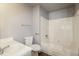 Clean bathroom featuring a shower-tub combo, white toilet, and vanity and light gray walls at 2235 Azalea Dr, Loganville, GA 30052