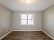 Clean bedroom with hardwood floors, natural light, and a neutral color scheme; light gray walls at 2235 Azalea Dr, Loganville, GA 30052
