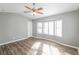 Bright bedroom with vaulted ceilings, ceiling fan, hardwood floors and lots of natural light and light gray walls at 2235 Azalea Dr, Loganville, GA 30052