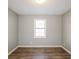 Bedroom with hardwood floors, natural light, and a neutral color scheme; light gray walls at 2235 Azalea Dr, Loganville, GA 30052