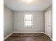 This bedroom features a window with blinds and hardwood floors at 2235 Azalea Dr, Loganville, GA 30052