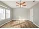Bright bedroom with vaulted ceilings, ceiling fan, hardwood floors and lots of natural light and light gray walls at 2235 Azalea Dr, Loganville, GA 30052