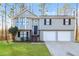 Charming two-story home featuring a two-car garage and a well-maintained lawn and traditional siding at 2235 Azalea Dr, Loganville, GA 30052