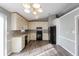 Well-lit kitchen with modern appliances, lots of cabinets, and hardwood floors and light gray walls at 2235 Azalea Dr, Loganville, GA 30052