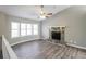 Bright living room with stone fireplace, vaulted ceilings, and large windows; light gray walls at 2235 Azalea Dr, Loganville, GA 30052