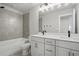 Bright bathroom features dual sinks, modern fixtures, and a tiled shower-over-tub at 4477 Bethany Manor Dr, Snellville, GA 30039