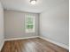 Bedroom featuring wood-look flooring and a window view of the outdoors at 4477 Bethany Manor Dr, Snellville, GA 30039