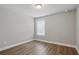 Bedroom boasts wood-look flooring, a window, and neutral paint at 4477 Bethany Manor Dr, Snellville, GA 30039