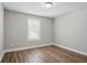 Neutral bedroom featuring wood-look flooring and a window view of the outdoors at 4477 Bethany Manor Dr, Snellville, GA 30039