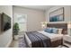 Cozy bedroom with hardwood floors, a queen bed, side tables, lamps, and art pieces at 4477 Bethany Manor Dr, Snellville, GA 30039