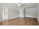 Spacious bedroom with wood-look flooring and a ceiling fan and ensuite bathroom access at 4477 Bethany Manor Dr, Snellville, GA 30039