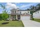 Charming two-story home with brick and siding, well-manicured lawn, and a two car garage at 4477 Bethany Manor Dr, Snellville, GA 30039