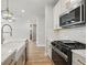 The modern kitchen features stainless steel appliances, a farmhouse sink, and a kitchen island at 4477 Bethany Manor Dr, Snellville, GA 30039