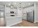 This kitchen features stainless steel appliances, modern pendant lighting, and white cabinetry at 4477 Bethany Manor Dr, Snellville, GA 30039