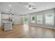 Bright and open living space with hardwood floors, large windows, and a view of the kitchen at 4477 Bethany Manor Dr, Snellville, GA 30039