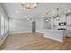 Open-concept floorplan combines a living room and a kitchen with ample natural light and hardwood floors at 4477 Bethany Manor Dr, Snellville, GA 30039