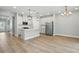 Spacious open-concept kitchen and living area with hardwood floors, stainless steel appliances, and ample natural light at 4477 Bethany Manor Dr, Snellville, GA 30039