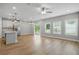 Spacious open-concept kitchen and living area with hardwood floors, stainless steel appliances, and ample natural light at 4477 Bethany Manor Dr, Snellville, GA 30039