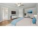 Main bedroom features ceiling fan, large ensuite bathroom, and hardwood floors at 4477 Bethany Manor Dr, Snellville, GA 30039