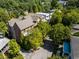 Aerial view showcasing a multi-story home with a brick exterior nestled amongst lush green trees at 970 N Ormewood Park Se Dr, Atlanta, GA 30316