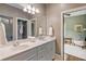 Well-lit bathroom with double vanity and doorway leading to bedroom at 970 N Ormewood Park Se Dr, Atlanta, GA 30316