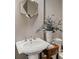 Bathroom featuring a pedestal sink with classic fixtures, and stylish decor at 970 N Ormewood Park Se Dr, Atlanta, GA 30316