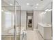 Bright bathroom featuring a double vanity, soaking tub, glass-enclosed shower, and walk-in closet at 970 N Ormewood Park Se Dr, Atlanta, GA 30316