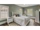 Relaxing bedroom featuring a white wood bed, shuttered windows, and calming green walls at 970 N Ormewood Park Se Dr, Atlanta, GA 30316