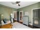 Guest bedroom with olive-green walls, gray dresser, and lots of natural light at 970 N Ormewood Park Se Dr, Atlanta, GA 30316