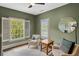 Bedroom with olive-green walls, sitting area, hardwood floors, and lots of natural light at 970 N Ormewood Park Se Dr, Atlanta, GA 30316