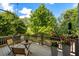 Outdoor deck area with natural landscaping and wood chairs and table at 970 N Ormewood Park Se Dr, Atlanta, GA 30316