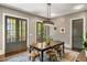Dining room with a view of the patio through the glass doors and modern light fixture at 970 N Ormewood Park Se Dr, Atlanta, GA 30316