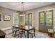 Dining room with modern light fixture, large table and doors that lead to the outside at 970 N Ormewood Park Se Dr, Atlanta, GA 30316