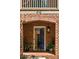 Inviting brick home featuring an arched entryway and a vibrant blue front door, complemented by lush greenery at 970 N Ormewood Park Se Dr, Atlanta, GA 30316