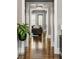Hallway with polished hardwood floors, neutral walls, and views into the living room beyond at 970 N Ormewood Park Se Dr, Atlanta, GA 30316