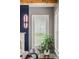 Chic interior with modern light fixture, window with shutters, and a vibrant potted plant adding a touch of nature at 970 N Ormewood Park Se Dr, Atlanta, GA 30316