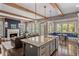 Open-concept living room and kitchen with hardwood floors, wooden beams, fireplace, and granite island at 970 N Ormewood Park Se Dr, Atlanta, GA 30316