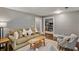 Cozy living room with comfortable seating, hardwood floors, and view into adjoining room at 970 N Ormewood Park Se Dr, Atlanta, GA 30316