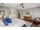 Comfortable main bedroom with ceiling fan, hardwood floors, built-in shelves, and a quaint sitting area at 970 N Ormewood Park Se Dr, Atlanta, GA 30316