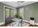 Bright home office featuring glass desk, shuttered windows, and serene views at 970 N Ormewood Park Se Dr, Atlanta, GA 30316