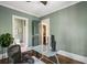 Comfortable office with glass desk, a ceiling fan, and a view into the bathroom at 970 N Ormewood Park Se Dr, Atlanta, GA 30316